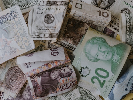 Assorted world currencies on a table